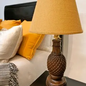 Wooden lamp with pineapple design and shade.