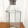 Metal lantern with a clear glass enclosure.