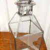 Clear glass lantern with metal accents.