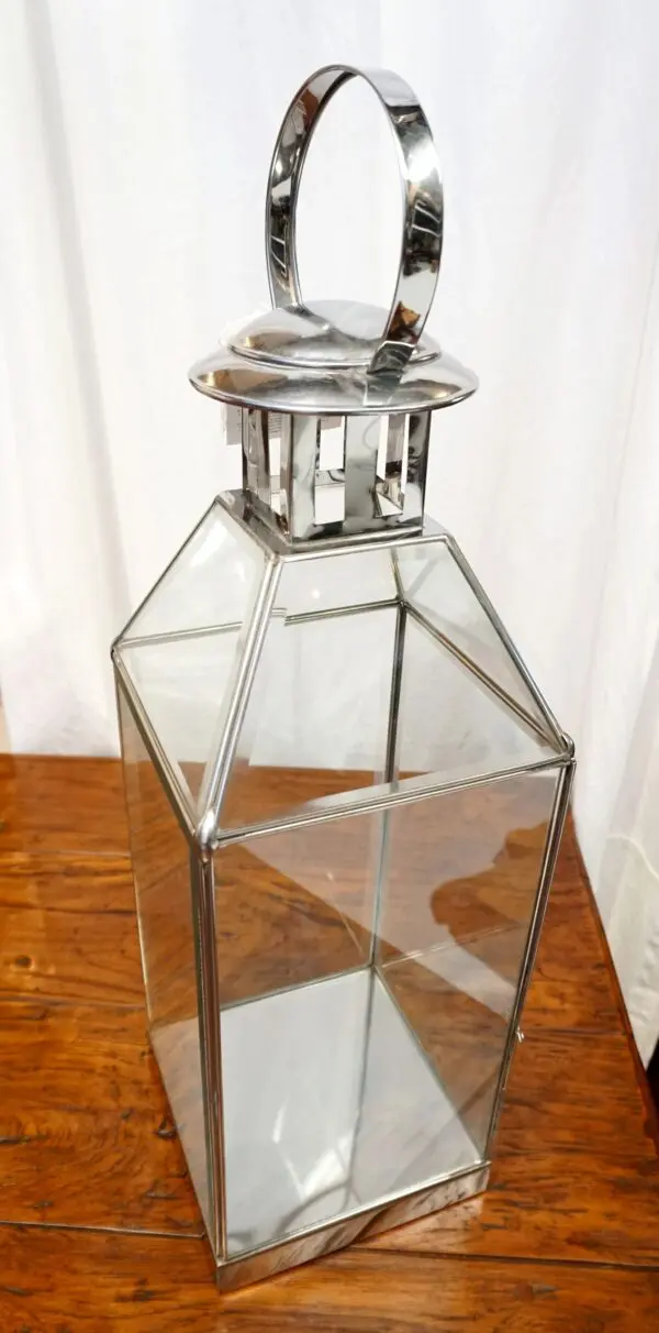 Clear glass lantern with metal accents.