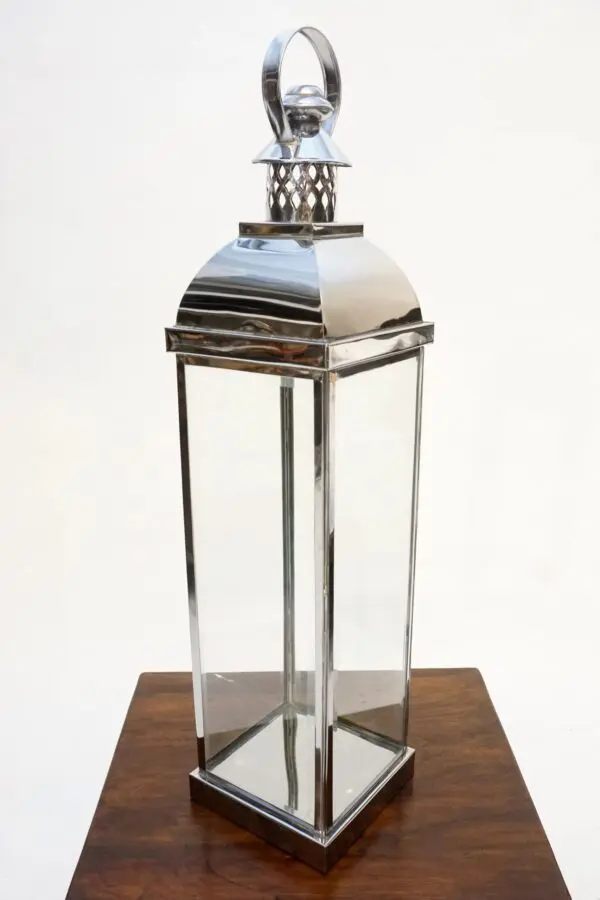 Metal lantern with glass panels and handle.