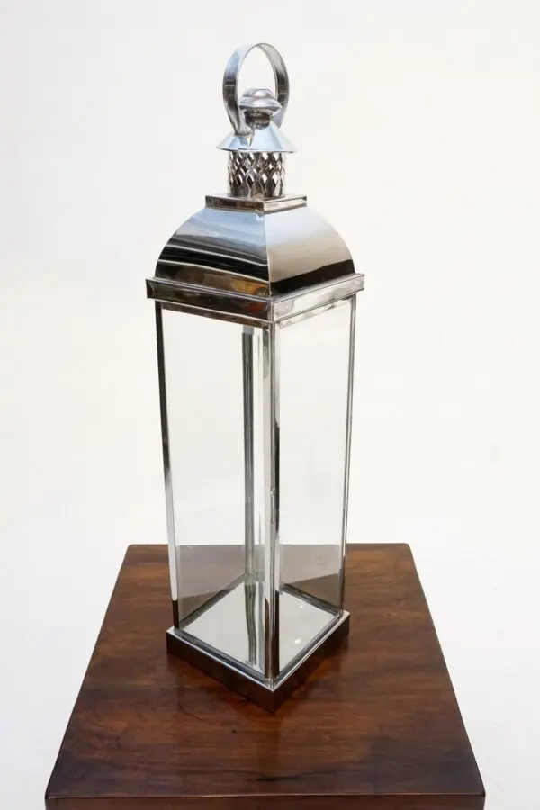 Silver lantern on a wooden table.