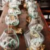 Glass vases arranged on wooden support.