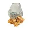Glass vase on textured wooden base.