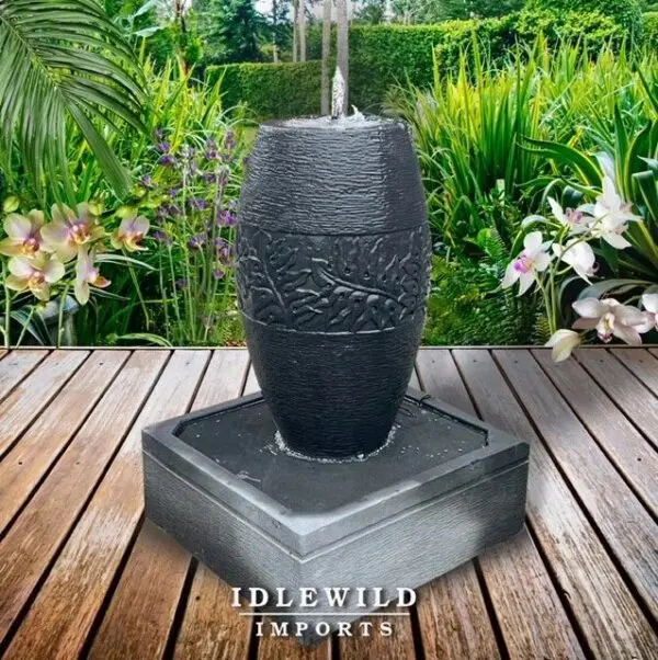 Black decorative water fountain in garden.