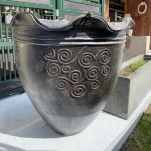 Decorative black pot with swirling patterns.