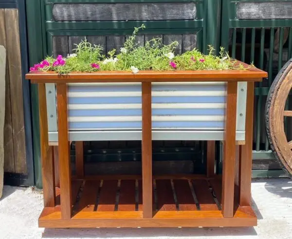 Wooden planter box with colorful flowers.