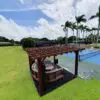 Wooden pergola with seating area outdoors.