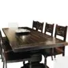 A table with six chairs and a bowl on top of it.