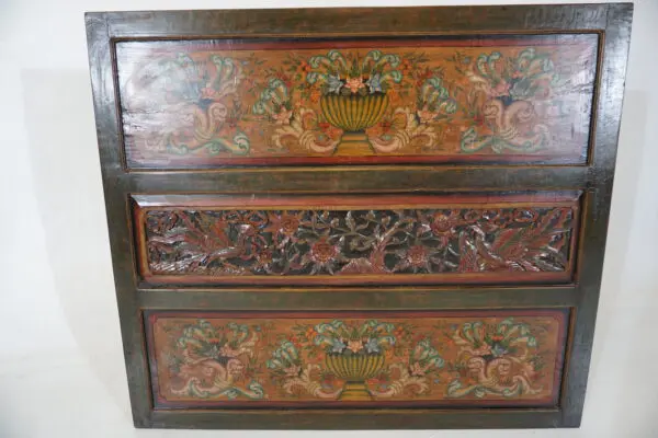 Decorative wooden chest with floral patterns.