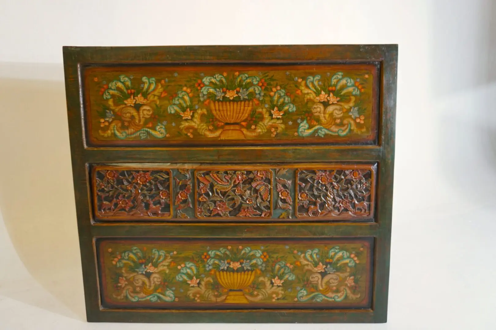 Antique wooden chest with floral carvings.