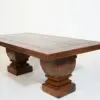 A wooden table with two large pillars on top of it.