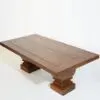 A wooden table with two pillars on top of it.