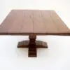 Wooden table with a square top.