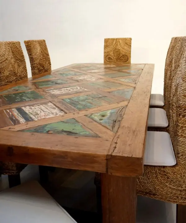 Wooden dining table with woven chairs.