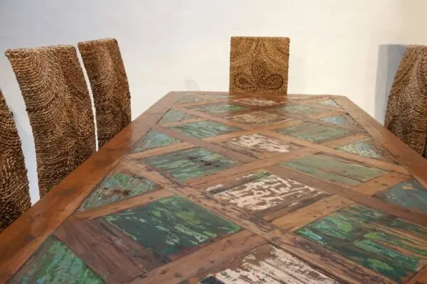 Wooden dining table with woven chairs.