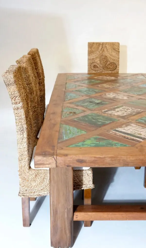 Wooden dining table with woven chairs.