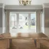 A large wooden table in front of a window.