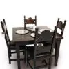A table with four chairs and plates on top of it.