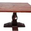 Wooden table with ornate pedestal base.