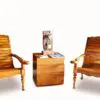 Two wooden chairs and a table with magazines on top of it.