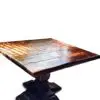 Wooden table with intricate design and shadows.