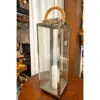 A large glass and metal lantern with a candle.