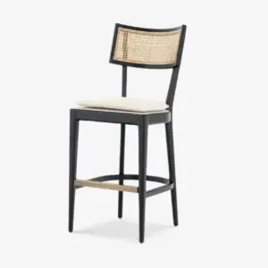 A black stool with a white cushion on top of it.