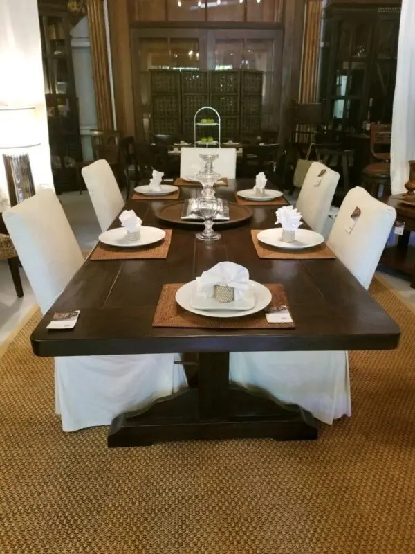 Elegant dining table set with white chairs.