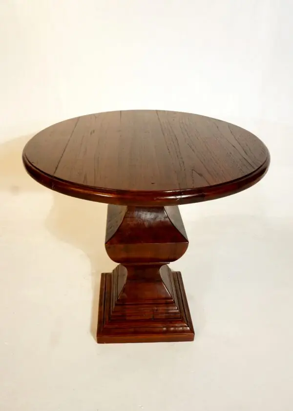 Round wooden table with pedestal base.