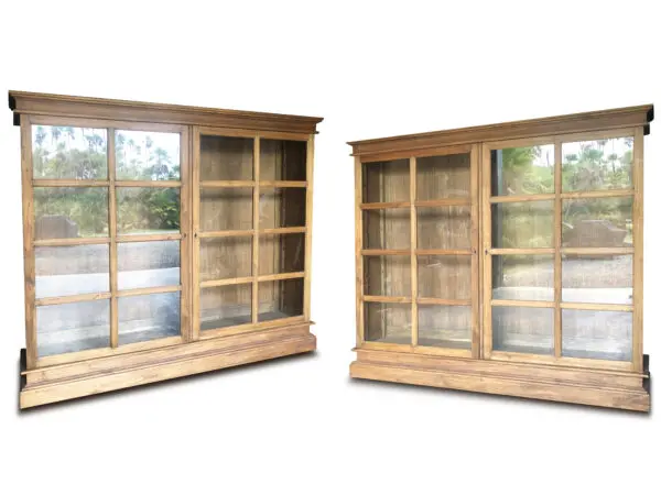 Two wooden display cabinets with glass doors.