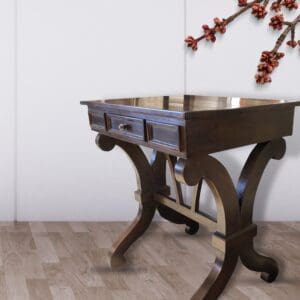 Dark wood console table with ornate legs.