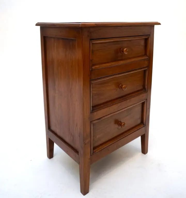 A wooden dresser with three drawers and a small table.