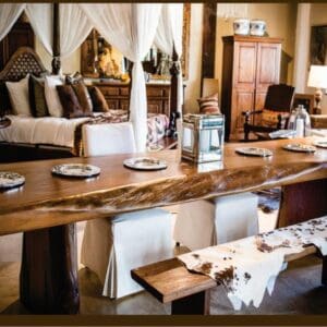 A dining room table with plates and silverware on it.