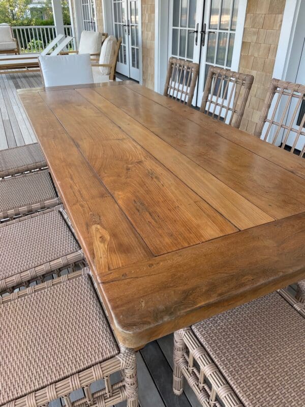 A large wooden table with two chairs on top of it.