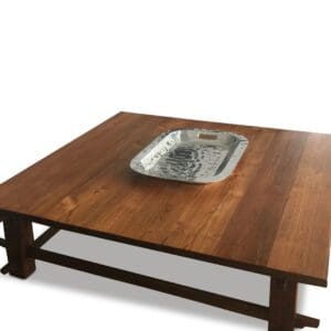 A wooden table with a metal tray on top of it.