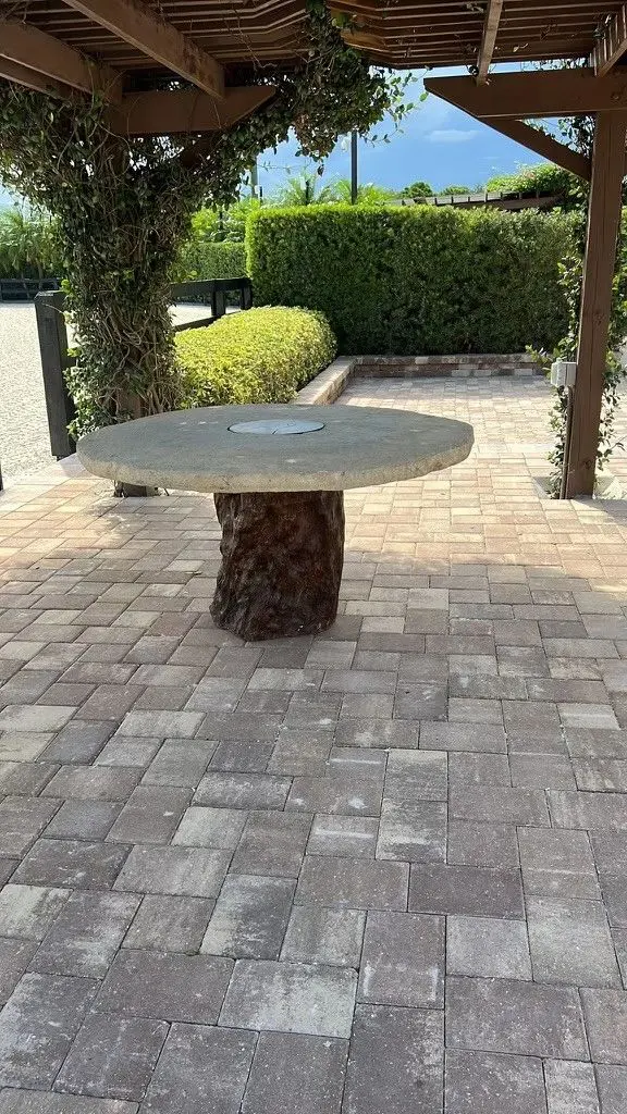 A table made out of tree trunks and concrete.