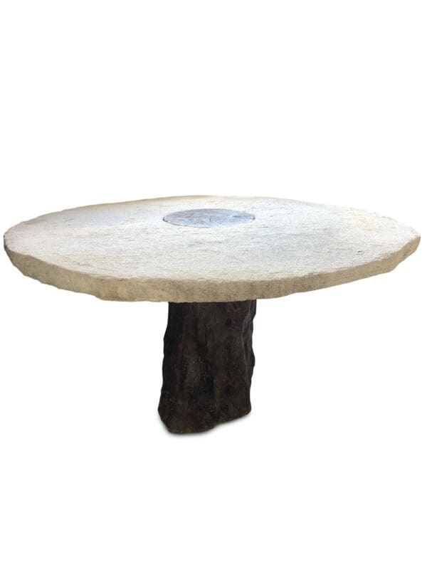 A table with a round top and a tree trunk base.