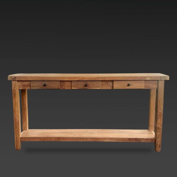 A wooden table with three drawers and a shelf.