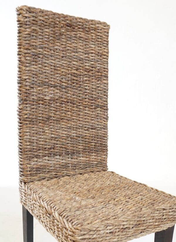 A chair made of woven grass and metal frame.