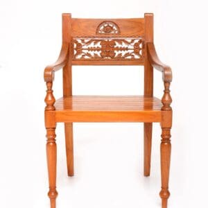 A wooden chair with carved designs on the back.