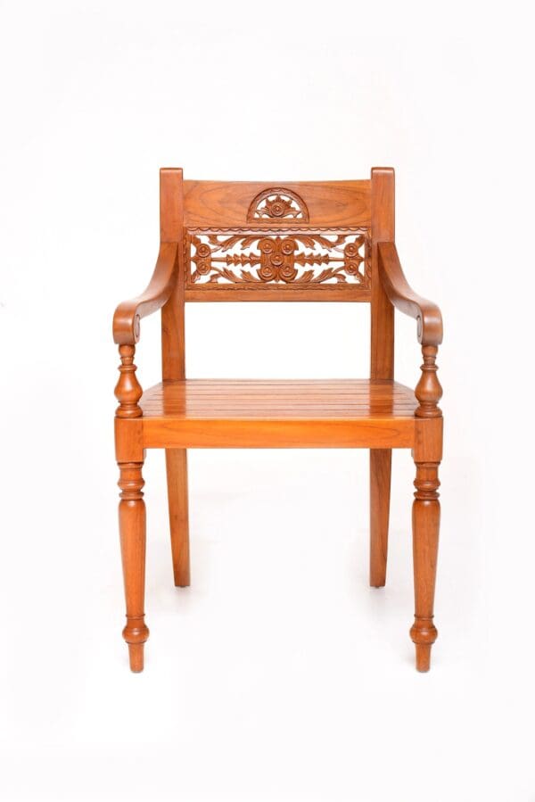 A wooden chair with carved designs on the back.