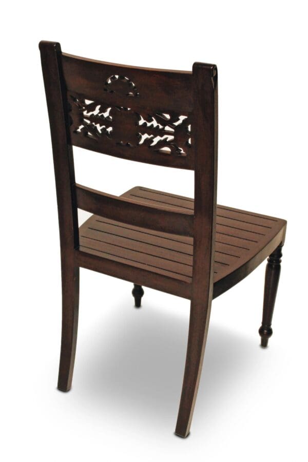 A wooden chair with carved back and seat.