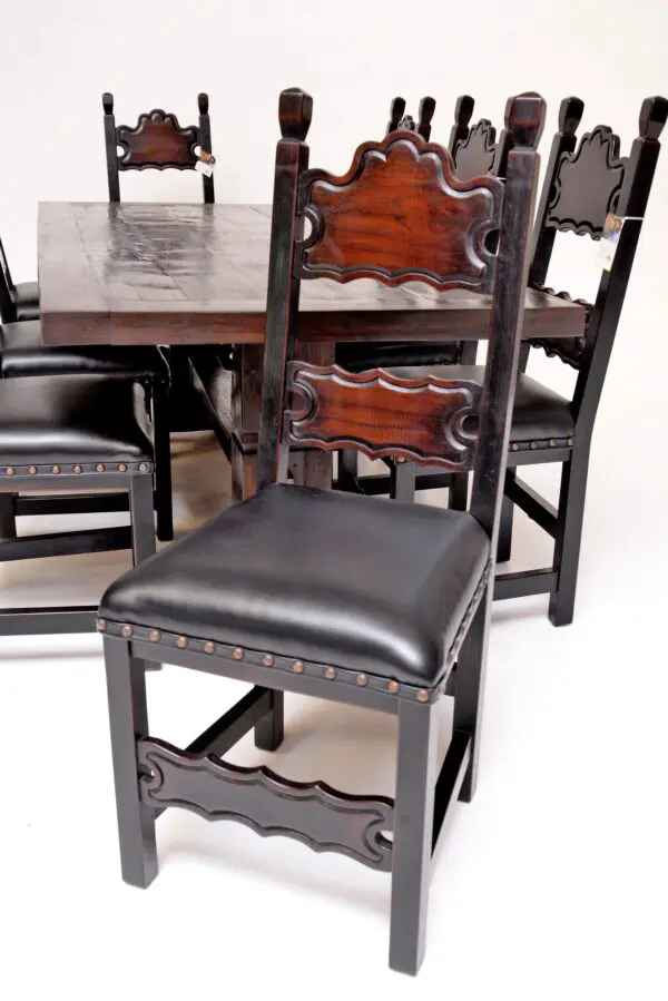 A wooden table with chairs and a black chair