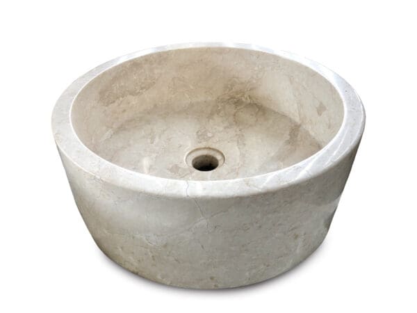 A white bowl shaped sink with a hole in the center.