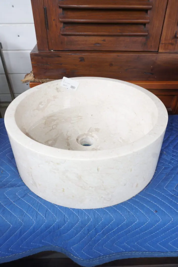 A white sink sitting on top of a blue table.