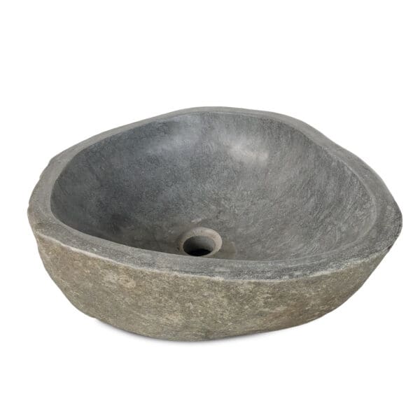 A stone sink with a hole in the center.