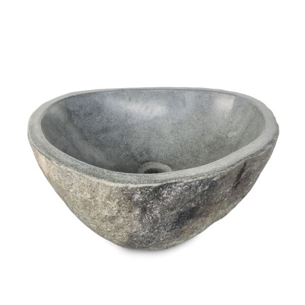 A bowl shaped stone sink with a single hole.