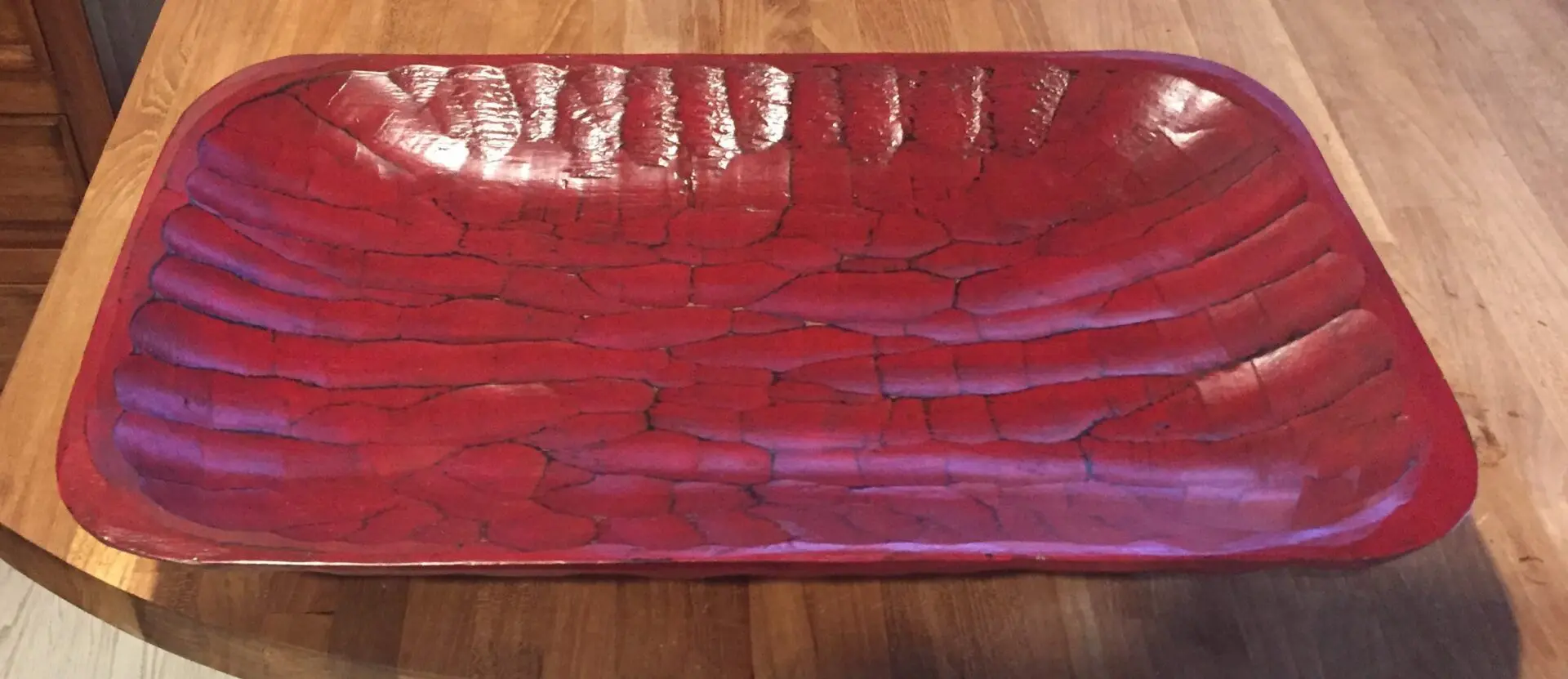 A red tray with some brown lines on it