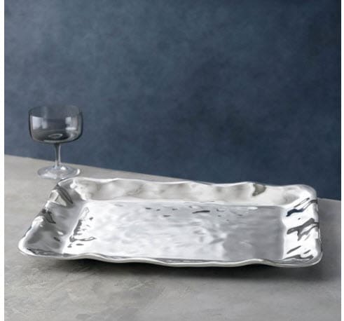 A silver tray with wine glasses on top of it.